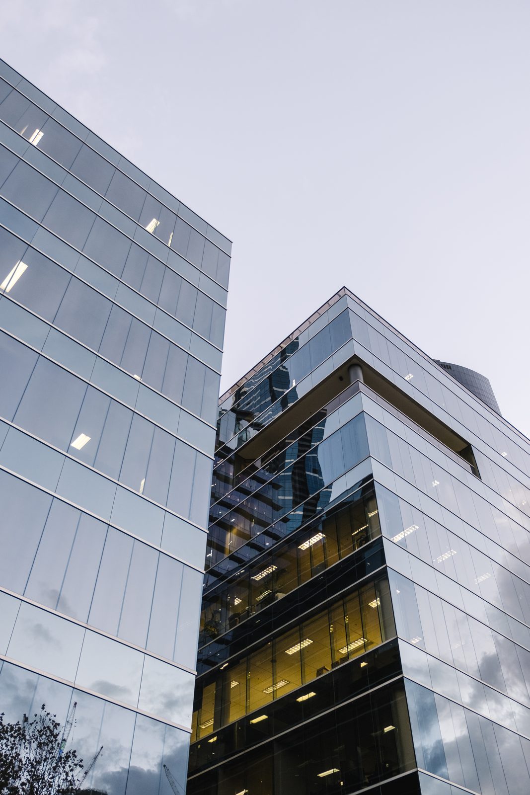 A curved glass building reflecting its surroundings